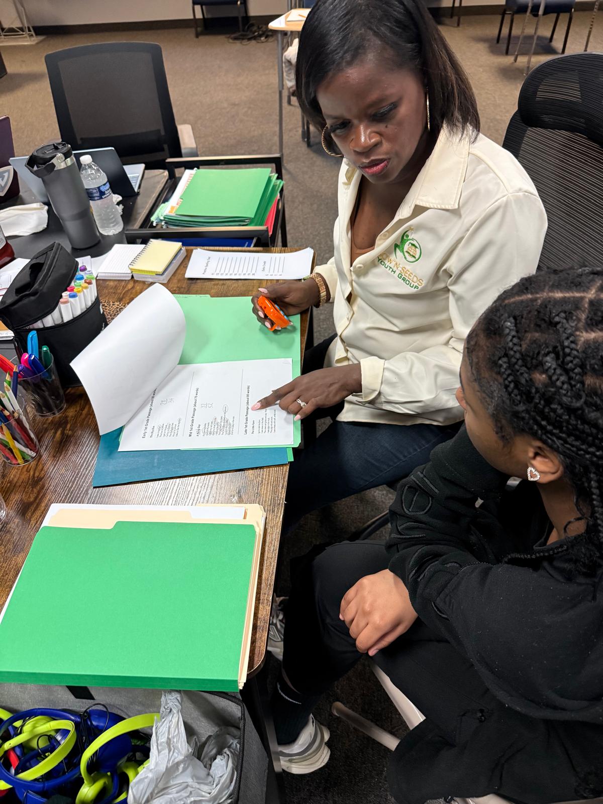 Sow'N Seeds educator supporting a scholar during an educational activity