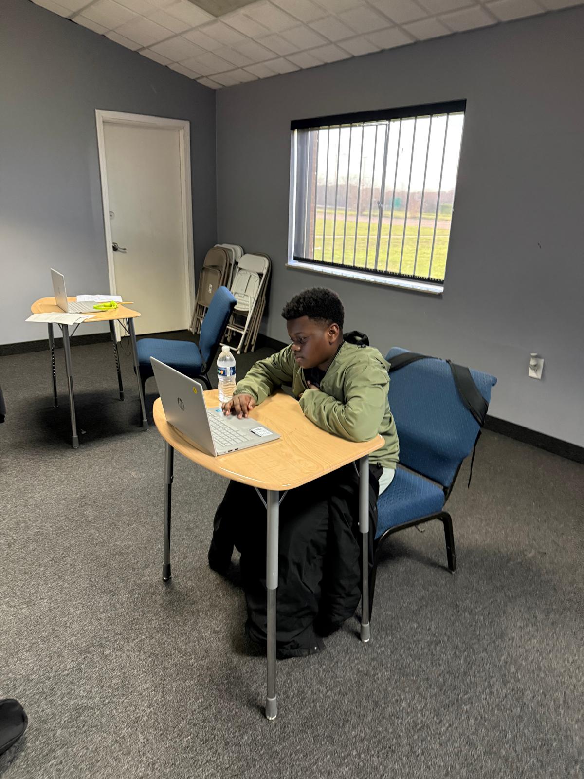 Sow'N Seeds scholar completing classroom work on a laptop